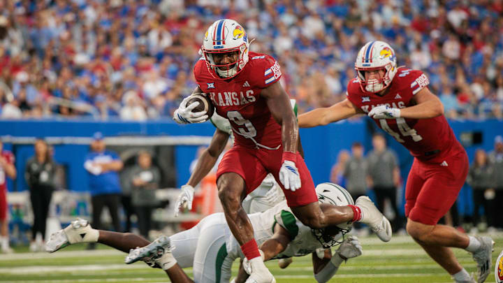 Aug 29, 2025; Lawrence, Kansas, USA; Kansas Jayhawks running back Daniel Hishaw Jr. (9) runs the ball during the second half against the Wagner Seahawks at David Booth Kansas Memorial Stadium. Mandatory Credit: William Purnell-Imagn Images