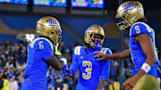 Nov 8, 2025; Pasadena, California, USA; UCLA Bruins running back Anthony Woods (6) celebrates his touchdown scored against the Nebraska Cornhuskers with wide receiver Kwazi Gilmer (3) and quarterback Nico Iamaleava (9) during the second half at the Rose Bowl. Mandatory Credit: Gary A. Vasquez-Imagn Images