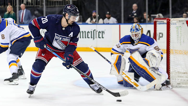 Mar 9, 2024; New York, New York, USA; New York Rangers left wing Chris Kreider (20) takes a shot at St. Louis Blues goalie Jordan Binnington (50) during the second period at Madison Square Garden. Mandatory Credit: Danny Wild-Imagn Images