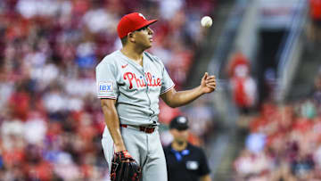 Aug 12, 2025; Cincinnati, Ohio, USA; Philadelphia Phillies starting pitcher Ranger Suarez (55) tosses a ball during a stop in play in the sixth inning against the Cincinnati Reds at Great American Ball Park.