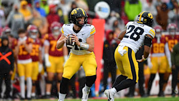 Nov 15, 2025; Los Angeles, California, USA; Iowa Hawkeyes quarterback Mark Gronowski (11) drops back to pass against the Southern California Trojans during the first half at the Los Angeles Memorial Coliseum. Mandatory Credit: Gary A. Vasquez-Imagn Images