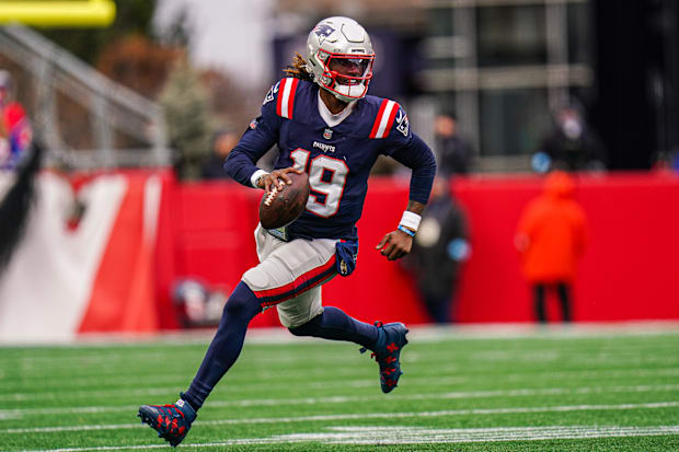  New England Patriots quarterback Joe Milton III runs the ball against the Buffalo Bills.