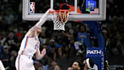 Oct 27, 2025; Dallas, Texas, USA; Oklahoma City Thunder center Isaiah Hartenstein (55) dunks the ball as Dallas Mavericks forward P.J. Washington (25) and forward Anthony Davis (3) look on during the second half at the American Airlines Center. Mandatory Credit: Jerome Miron-Imagn Images