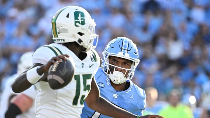 Sep 7, 2024; Chapel Hill, North Carolina, USA; Charlotte 49ers quarterback Deshawn Purdie (15) looks to pass as DUPLICATE***North Carolina Tar Heels linebacker Amare Campbell (17)***North Carolina Tar Heels quarterback Michael Merdinger (17) pressures in the third quarter at Kenan Memorial Stadium. Mandatory Credit: Bob Donnan-Imagn Images