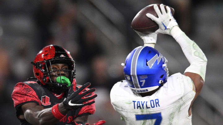 Nov 26, 2022; San Diego, California, USA; Air Force Falcons safety Trey Taylor (7) intercepts a pass intended for San Diego State Aztecs wide receiver Tyrell Shavers (14) during the second half at Snapdragon Stadium. Mandatory Credit: Orlando Ramirez-USA TODAY Sports