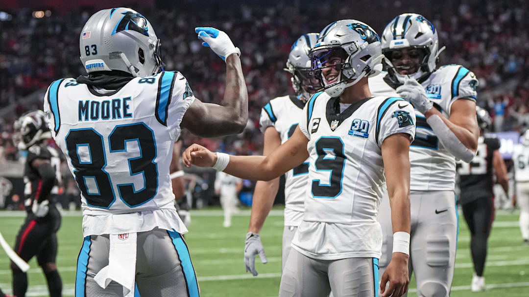 Jan 5, 2025; Atlanta, Georgia, USA; Carolina Panthers quarterback Bryce Young (9) reacts with wide receiver David Moore (83) after running for a touchdown against the Atlanta Falcons during the second half at Mercedes-Benz Stadium.