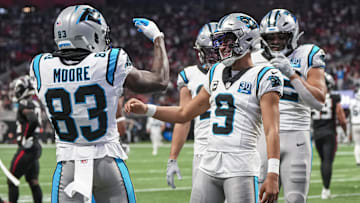 Jan 5, 2025; Atlanta, Georgia, USA; Carolina Panthers quarterback Bryce Young (9) reacts with wide receiver David Moore (83) after running for a touchdown against the Atlanta Falcons during the second half at Mercedes-Benz Stadium.