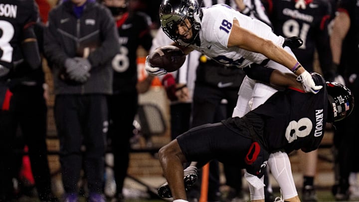 Nov 30, 2024; Cincinnati, Ohio, USA; Cincinnati Bearcats cornerback Ormanie Arnold (8) tackles TCU Horned Frogs wide receiver Jack Bech (18) in the first quarter at Nippert Stadium. Mandatory Credit: Albert Cesare/USA TODAY Network via Imagn Images Nov 30, 2024; Cincinnati, Ohio, USA; Cincinnati Bearcats cornerback Ormanie Arnold (8) tackles TCU Horned Frogs wide receiver Jack Bech (18) in the first quarter at Nippert Stadium. Mandatory Credit: Albert Cesare/USA TODAY Network via Imagn Images
