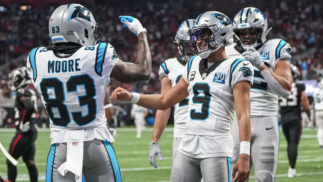 Jan 5, 2025; Atlanta, Georgia, USA; Carolina Panthers quarterback Bryce Young (9) reacts with wide receiver David Moore (83) after running for a touchdown against the Atlanta Falcons during the second half at Mercedes-Benz Stadium. Mandatory Credit: Dale Zanine-Imagn Images