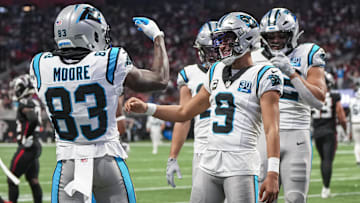 Jan 5, 2025; Atlanta, Georgia, USA; Carolina Panthers quarterback Bryce Young (9) reacts with wide receiver David Moore (83) after running for a touchdown against the Atlanta Falcons during the second half at Mercedes-Benz Stadium. Mandatory Credit: Dale Zanine-Imagn Images