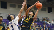 Dec 1, 2022; Montverde, Florida, USA; Montverde Academy forward Asa Newell (14) shoots past IMG Academy forward Bryson Tucker (3)