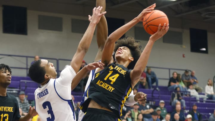 Dec 1, 2022; Montverde, Florida, USA; Montverde Academy forward Asa Newell (14) shoots past IMG Academy forward Bryson Tucker (3)