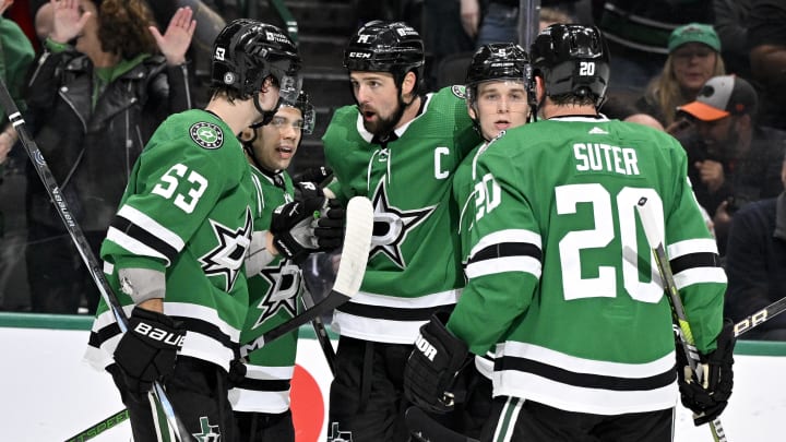 Mar 20, 2024; Dallas, Texas, USA; Dallas Stars center Wyatt Johnston (53) and center Logan Stankoven (11) and left wing Jamie Benn (14) and defenseman Nils Lundkvist (5) and defenseman Ryan Suter (20) celebrates a goal scored by Benn against the Arizona Coyotes during the second period at the American Airlines Center. Mandatory Credit: Jerome Miron-USA TODAY Sports