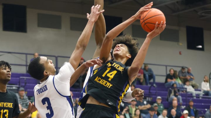 Dec 1, 2022; Montverde, Florida, USA; Montverde Academy forward Asa Newell (14) shoots past IMG Academy forward Bryson Tucker (3) during the second half of the Sunshine Classic basketball tournament at Mills Championship Court on the campus of Montverde Academy. Mandatory Credit: Reinhold Matay-USA TODAY Sports