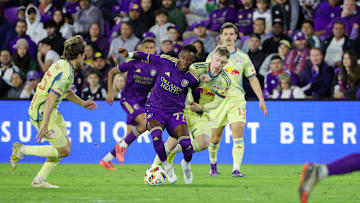 Nov 30, 2024; Orlando, Florida, USA; Orlando City midfielder Ivan Angulo (77) dribbles the ball against New York Red Bulls during the second half in the 2024 MLS Cup Eastern Conference Final match at Inter&Co Stadium. Mandatory Credit: Mike Watters-Imagn Images
