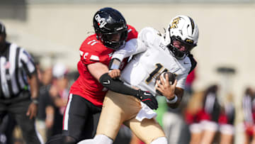 Oct 11, 2025; Cincinnati, Ohio, USA; Cincinnati Bearcats linebacker Jake Golday (11) attempts to tackle UCF Knights quarterback Cam Fancher (14) in the second half at Nippert Stadium. Mandatory Credit: Aaron Doster-Imagn Images