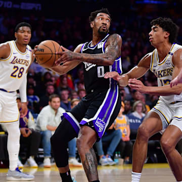 Dec 28, 2024; Los Angeles, California, USA;  Sacramento Kings guard Malik Monk (0) controls the ball against Los Angeles Lakers guard Max Christie (12) during the first half at Crypto.com Arena. Mandatory Credit: Gary A. Vasquez-Imagn Images