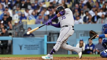 Jun 1, 2024; Los Angeles, California, USA;  Colorado Rockies catcher Elias Diaz (35) hits a single during the third inning against the Los Angeles Dodgers at Dodger Stadium. Mandatory Credit: Kiyoshi Mio-USA TODAY Sports