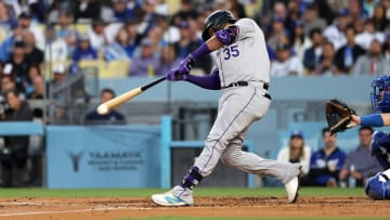 Jun 1, 2024; Los Angeles, California, USA;  Colorado Rockies catcher Elias Diaz (35) hits a single during the third inning against the Los Angeles Dodgers at Dodger Stadium. Mandatory Credit: Kiyoshi Mio-USA TODAY Sports