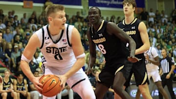 Nov 25, 2024; Lahaina, Hawaii, USA;  Michigan State Spartans forward Jaxon Kohler (0) tries to make a pass as Colorado Buffaloes forward Bangot Dak (8) guards him in the first half of an NCAA college basketball game at Lahaina Civic Center. Mandatory Credit: Marco Garcia-Imagn Images