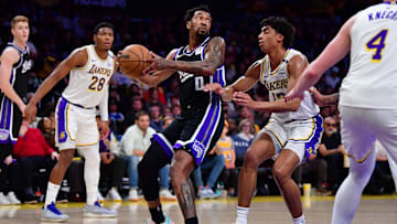 Dec 28, 2024; Los Angeles, California, USA;  Sacramento Kings guard Malik Monk (0) controls the ball against Los Angeles Lakers guard Max Christie (12) during the first half at Crypto.com Arena. Mandatory Credit: Gary A. Vasquez-Imagn Images