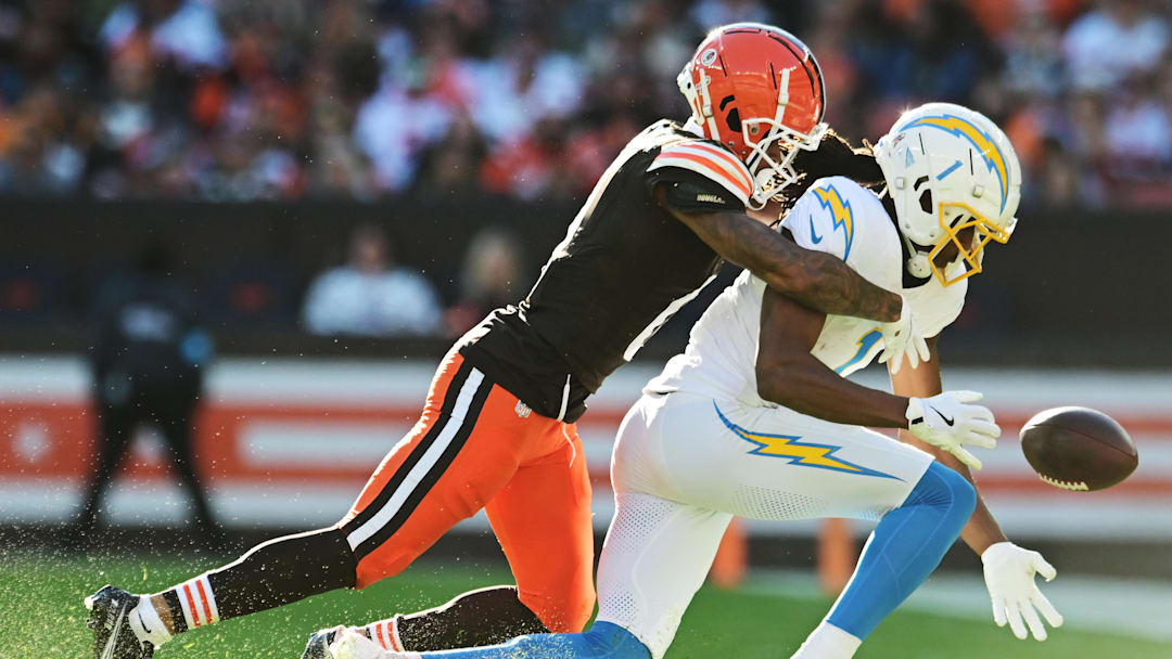Nov 3, 2024; Cleveland, Ohio, USA; Cleveland Browns cornerback Greg Newsome II (0) knocks the ball away from Los Angeles Chargers wide receiver Quentin Johnston (1) during the second half at Huntington Bank Field. Mandatory Credit: Ken Blaze-Imagn Images