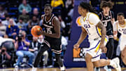 Feb 18, 2025; Baton Rouge, Louisiana, USA;  South Carolina Gamecocks guard Morris Ugusuk (15) dribbles against LSU Tigers guard Jordan Sears (1) during the second half at Pete Maravich Assembly Center. Mandatory Credit: Stephen Lew-Imagn Images