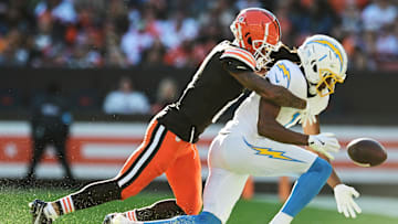 Nov 3, 2024; Cleveland, Ohio, USA; Cleveland Browns cornerback Greg Newsome II (0) knocks the ball away from Los Angeles Chargers wide receiver Quentin Johnston (1) during the second half at Huntington Bank Field. Mandatory Credit: Ken Blaze-Imagn Images