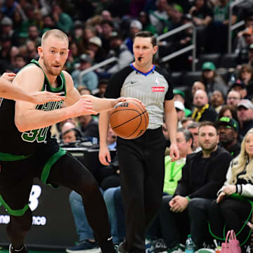Apr 6, 2025; Boston, Massachusetts, USA; Boston Celtics forward Sam Hauser (30) controls the ball while Washington Wizards guard Colby Jones (1) defends during the second half at TD Garden. Mandatory Credit: Bob DeChiara-Imagn Images