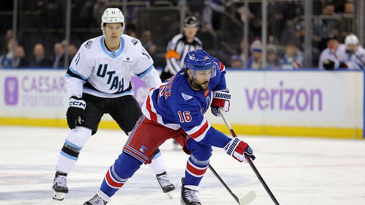 Jan 5, 2026; New York, New York, USA; New York Rangers center Vincent Trocheck (16) brings the puck up ice against Utah Mammoth right wing Dylan Guenther (11) during the second period at Madison Square Garden. Mandatory Credit: Brad Penner-Imagn Images
