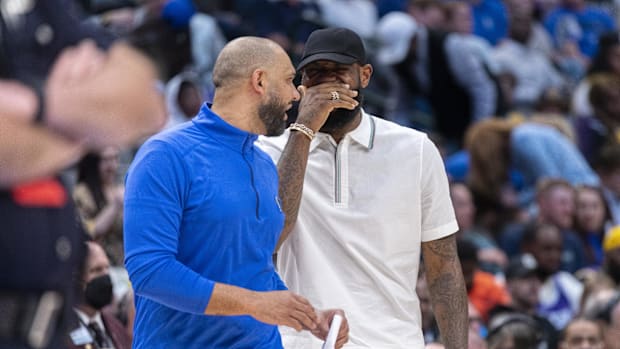 The Los Angeles Lakers LeBron James (right) attacker jokes with Dallas Mavericks assistant coach Jared Dudley (left)