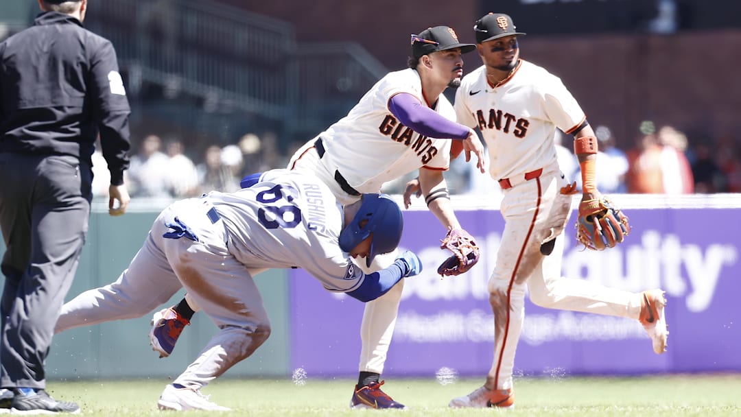 Dodgers catcher Dalton Rushing (68) slides into San Francisco Giants shortstop Willy Adames (2) trying to make the double play with second baseman Luis Arraez (1) during the sixth inning at Oracle Park on April 23, 2026.