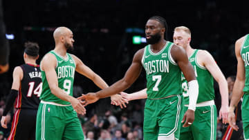Apr 24, 2024; Boston, Massachusetts, USA; Boston Celtics guard Jaylen Brown (7), forward Jayson Tatum (0), guard Derrick White (9) and forward Sam Hauser (30) walk to the bench during a timeout against the Miami Heat in the second quarter during game two of the first round for the 2024 NBA playoffs at TD Garden. Mandatory Credit: David Butler II-USA TODAY Sports