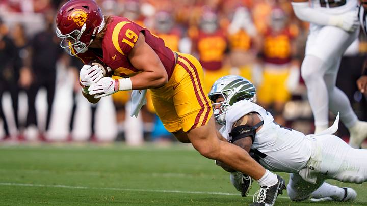 Oregon defensive back Aaron Flowers brings down USC tight end Mark Bowman as the Oregon Ducks face the USC Trojans on Sept. 26, 2026, at Los Angeles Memorial Coliseum in Los Angeles, California.