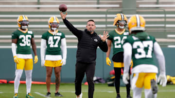 Green Bay Packers head coach Matt LaFleur throws the the ball to cornerback Johnathan Baldwin (37) during the team's first day of minicamp on June 10, 2025, at Ray Nitschke Field in Ashwaubenon, Wis.