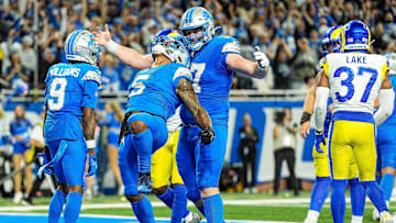 Detroit Lions running back David Montgomery celebrates his winning 1-yard touchdown run to defeat the Los Angeles Rams, 26-20, during overtime at Ford Field in Detroit on Sunday, Sept. 8, 2024. Lions receiver Jameson Williams and center Frank Ragnow also are fired up.