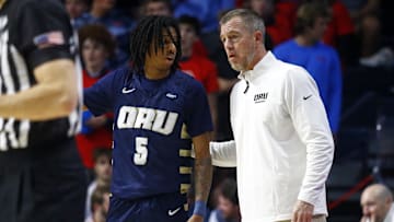 Nov 21, 2024; Oxford, Mississippi, USA; Oral Roberts Golden Eagles head coach Russell Springmann (right) talks with guard Darius Robinson Jr. (5) during the first half against the Mississippi Rebels at The Sandy and John Black Pavilion at Ole Miss. Mandatory Credit: Petre Thomas-Imagn Images