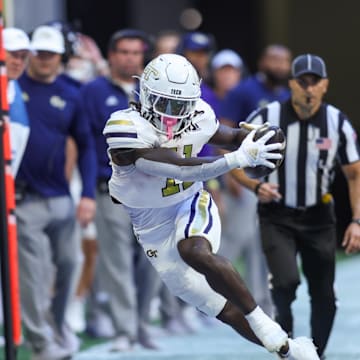 Oct 19, 2024; Atlanta, Georgia, USA; Georgia Tech Yellow Jackets running back Jamal Haynes (11) is pushed out of bounds by Notre Dame Fighting Irish linebacker Jaiden Ausberry (4) in the first quarter at Mercedes-Benz Stadium. Mandatory Credit: Brett Davis-Imagn Images