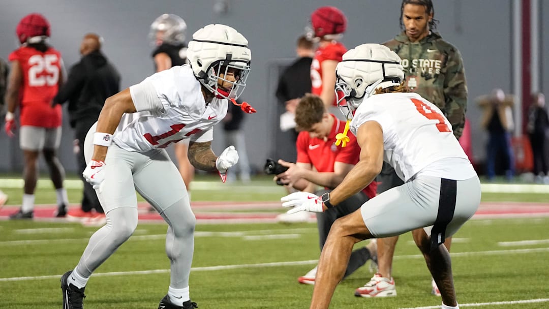 Ohio State Buckeyes cornerbacks Bryce West (12) and Devin Sanchez (4) complete a drill during spring football practice at the Woody Hayes Athletic Center in Columbus on March 17, 2025.