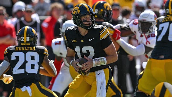 Aug 31, 2024; Iowa City, Iowa, USA; Iowa Hawkeyes quarterback Cade McNamara (12) drops back to pass during the first quarter against the Illinois State Redbirds at Kinnick Stadium. Mandatory Credit: Jeffrey Becker-USA TODAY Sports