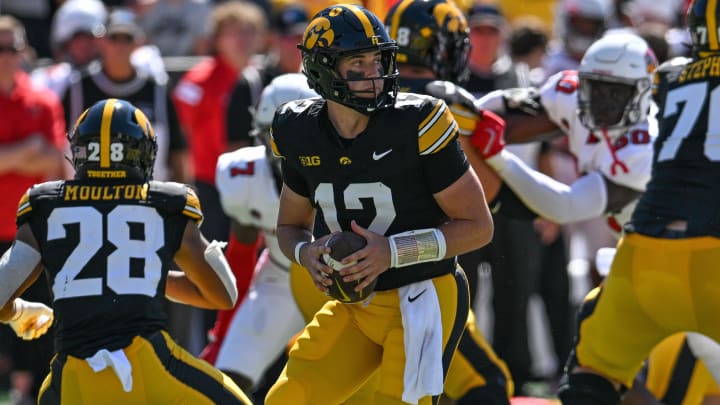 Aug 31, 2024; Iowa City, Iowa, USA; Iowa Hawkeyes quarterback Cade McNamara (12) drops back to pass during the first quarter against the Illinois State Redbirds at Kinnick Stadium. Mandatory Credit: Jeffrey Becker-USA TODAY Sports