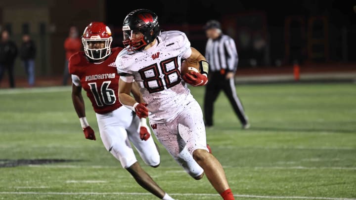 Lakota West tight end Luka Gilbert (88) runs with ball as he is chased by Princeton's Solomon Farrell (16) during the Firebirds' 19-7 win Friday, Nov. 10, 2023.