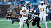Nov 9, 2025; Charlotte, North Carolina, USA; New Orleans Saints running back Alvin Kamara (41) rushes as Carolina Panthers linebacker Christian Rozeboom (56) defends during the fourth quarter at Bank of America Stadium. Mandatory Credit: Jim Dedmon-Imagn Images