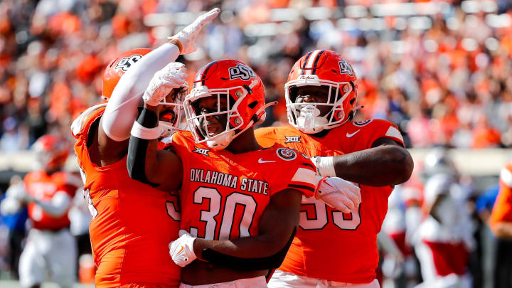 Oct 14, 2023; Stillwater, Oklahoma, USA; Oklahoma State's Collin Oliver (30) celebrates after a sack against the Kansas Jayhawks in the second quarter at Boone Pickens Stadium. Mandatory Credit: Nathan J. Fish-USA TODAY Sports