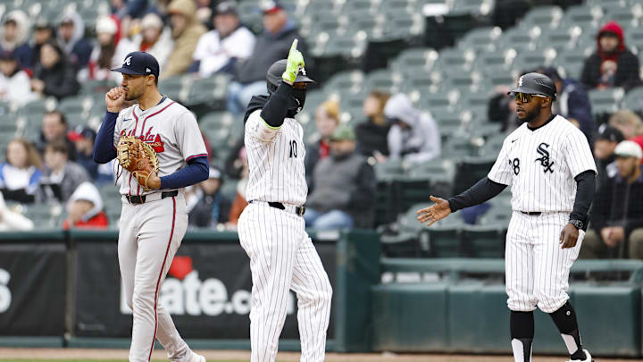 Chicago White Sox third baseman Yoan Moncada (10) reacts after getting a base hit off of Atlanta Braves pitcher Charlie Morton (not pictured) while Braves first baseman Matt Olson warms up his hand