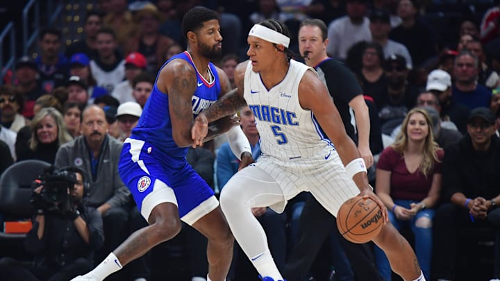 Orlando Magic forward Paolo Banchero (5) moves the ball against then-Los Angeles Clippers forward Paul George (13) during the first half at Crypto.com Arena.