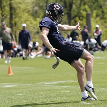 Tory Taylor steps into a punt during warmups at Halas Hall practice. The former Iowa punter was the Bears' fourth-round pick.