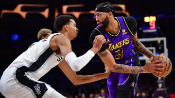 Feb 23, 2024; Los Angeles, California, USA; Los Angeles Lakers forward Anthony Davis (3) moves the ball against San Antonio Spurs center Victor Wembanyama (1) during the first half at Crypto.com Arena.