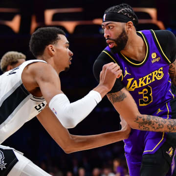 Feb 23, 2024; Los Angeles, California, USA; Los Angeles Lakers forward Anthony Davis (3) moves the ball against San Antonio Spurs center Victor Wembanyama (1) during the first half at Crypto.com Arena.