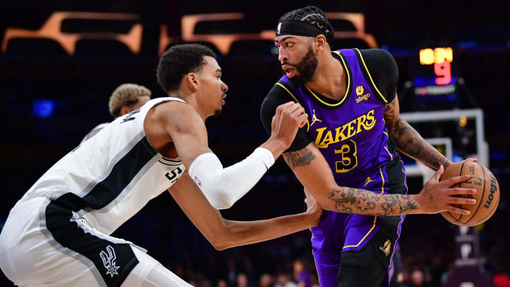 Feb 23, 2024; Los Angeles, California, USA; Los Angeles Lakers forward Anthony Davis (3) moves the ball against San Antonio Spurs center Victor Wembanyama (1) during the first half at Crypto.com Arena.